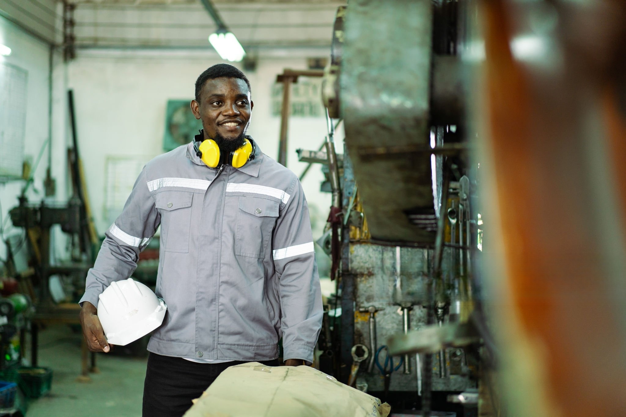 Tekle Berhan standing beside the equipment and smiling